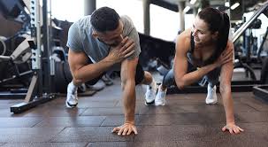 Sculpting Sleek Arms: The Essential Role of Cardio in Toning Without Bulking Up 1 Image of man and woman doing Cardio Rushden to tone their arms.